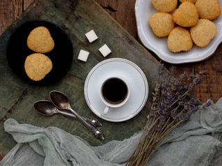 The composition of the gluten-free rice-banana muffin, a cup of coffee and a bouquet of lavender. Romantic breakfast. Vintage photo.