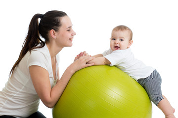 Fototapeta na wymiar Happy mother and baby making healthy gymnastics on fit ball