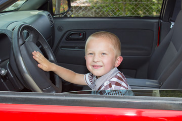boy in a red car