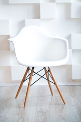 Conceptual Empty White Wooden Leg Chairs with white wall and gray wooden floor and copyspace