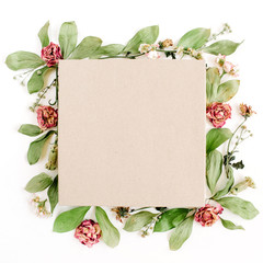 Craft gift box and floral composition with red roses and green leaves on white background. Flat lay, top view.