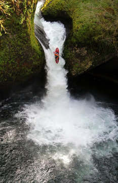 Kayaker going over waterfall
