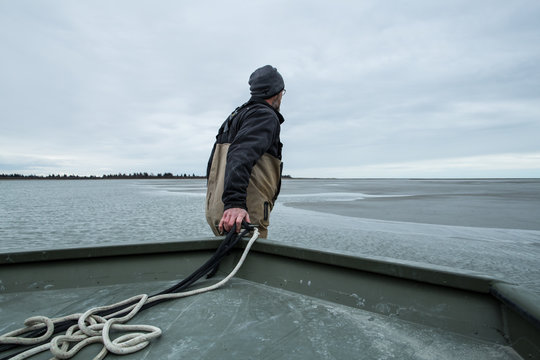 Man Pulling Boat To Water 