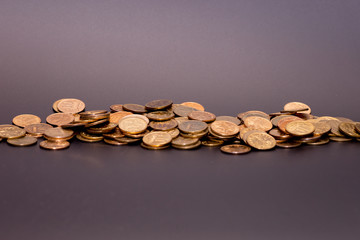 a scattering of coins on a black background