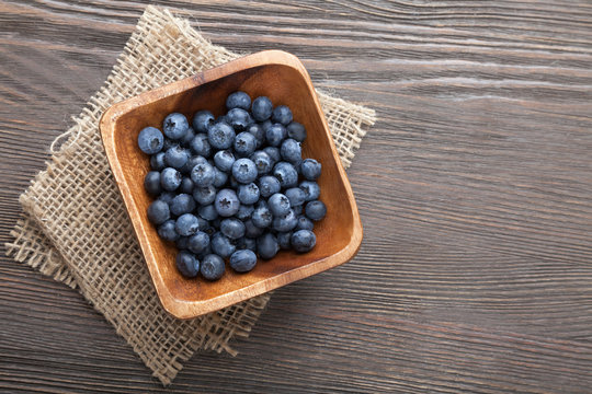 ripe sweet blueberries on wooden table