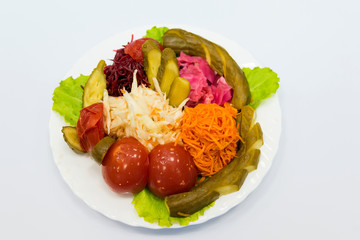 Serve canned vegetables laid out on plate: tomato, cucumber, cabbage, beets, carrots. How to preserve the taste and benefits of favorite vegetables for the winter.