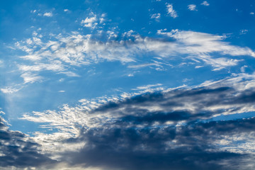 White curly clouds in a blue sky. Sky background