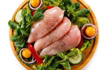 Raw chicken breasts on cutting board 