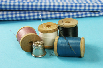 wooden spools with colored cotton threads for sewing, vintage