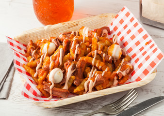 Colombian food: salchipapas with quail eggs.