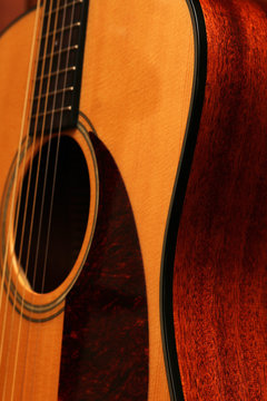 Shapes and curves of an acoustic guitar body.
