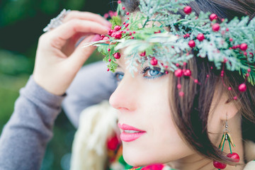 Naklejka premium Closeup portrait of beautiful young girl with a traditional Russian or Ukrainian scarf in the winter.
