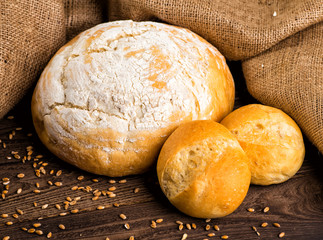 Freshly baked traditional bread with honey on a wooden table