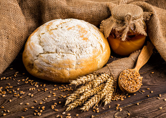 Freshly baked traditional bread with honey on a wooden table