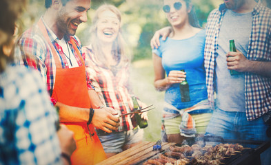 Friends having a barbecue party in nature - obrazy, fototapety, plakaty