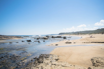 Seascape: beach, rocks and blue sky