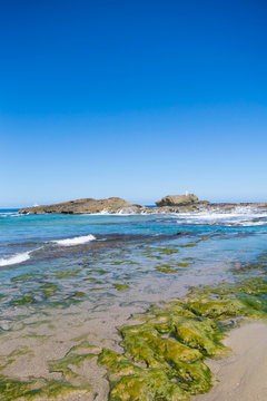 Seascape: beach, rocks and blue sky