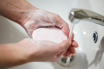 Hygiene concept. Woman washing hands close up