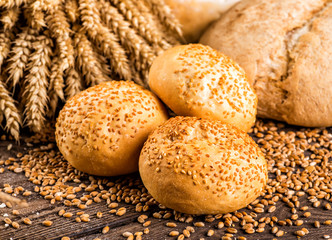Assortment of baked bread on wooden table background