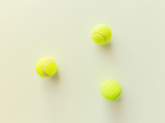 close up of three yellow tennis balls
