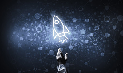 Technology idea concept with glowing rocket icon and touching it