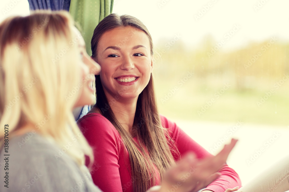 Poster happy young women talking in travel bus or train