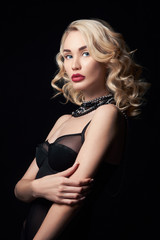 Fototapeta premium Sexy beautiful blonde girl with long hair. Perfect woman portrait on black background. Gorgeous hair and nice eyes. Natural beauty, clean skin, facial care and hair. Strong and thick hair. Jewelry