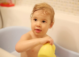 Young child sitting in bath