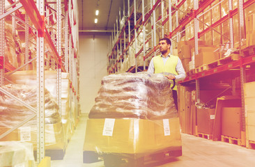 man carrying loader with goods at warehouse