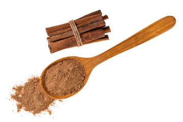 Cinnamon sticks with cinnamon powder on wooden spoon isolated on white background,macro shot