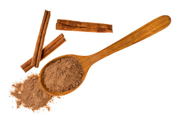 Cinnamon sticks with cinnamon powder on wooden spoon isolated on white background,macro shot