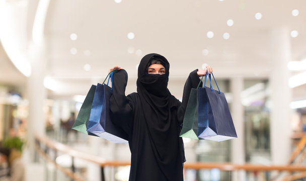 muslim woman in hijab with shopping bags