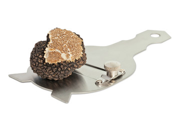 Large black truffle on a slicer