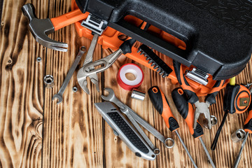   A toolbox with different instruments. A set of tools on a wooden background.