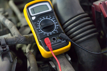 multimeter or voltmeter testing car battery