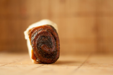 delicious Homemade muffins roll with poppy seeds in warm color background