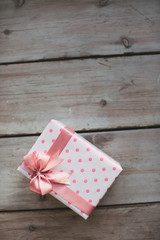 Gift ribbon on the wood old table.