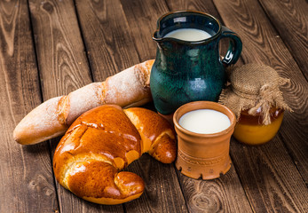 Tasty croissants with spikelets on grey wooden background