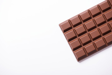 Tablet with chocolate milk on white background. Horizontal shoot.