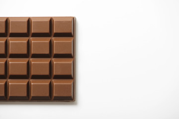 Tablet with chocolate milk on white background. Copy-space. Horizontal shoot.