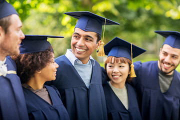 happy students or bachelors in mortar boards