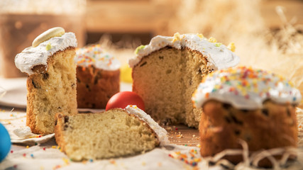 Cutting a piece of the Easter is near a large cake