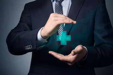 businessman hands closeup. a man in business suit shows caring gesture. life and health insurance.