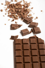 Tablet and chocolate chips on white background. Isolated. Vertical shoot.