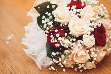 Beautiful bridal bouquet on the wooden background