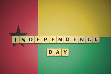 letters with text independence day on the national flag of guinea bissau.