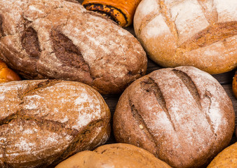 Many mixed breads and rolls shot from above.