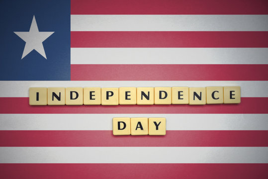 letters with text independence day on the national flag of liberia .