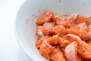 Raw Salmon with spicy sauce in bowl.