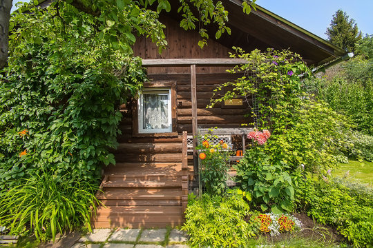 wooden house with blossoming garden
